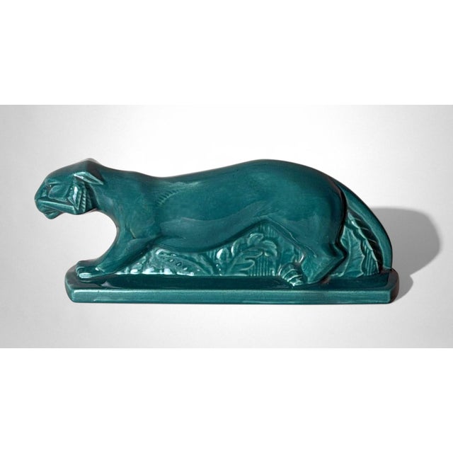 Elegant and finely crafted Art Deco–style panther in green-glazed ceramic, produced in France. The proud animal is...