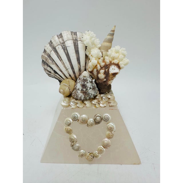 This elegant shell sculpture is a refined blend of natural marine elements and luxurious Italian marble, embodying a...