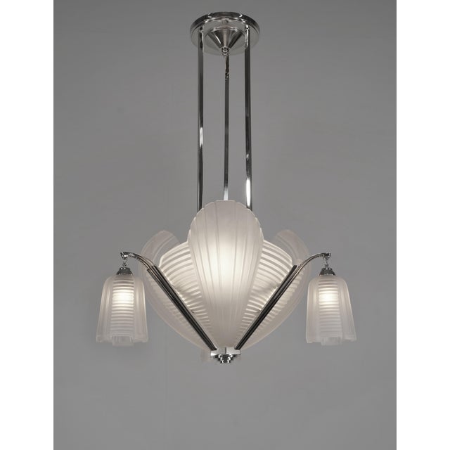Cleopatra chandelier by H. Petitot A large French 1933 art deco chandelier in nickeled brass or bronze by the famous Paris...