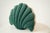 Whimsical and sculptural, this seashell-shaped throw pillow in deep green brings coastal charm and playful artistry to any...