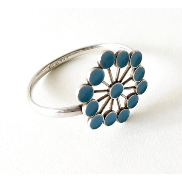 Rare Danish modernist bangle bracelet designed by Astrid Fog for Georg Jensen. Bracelets flower element measures 1 7/8" in...