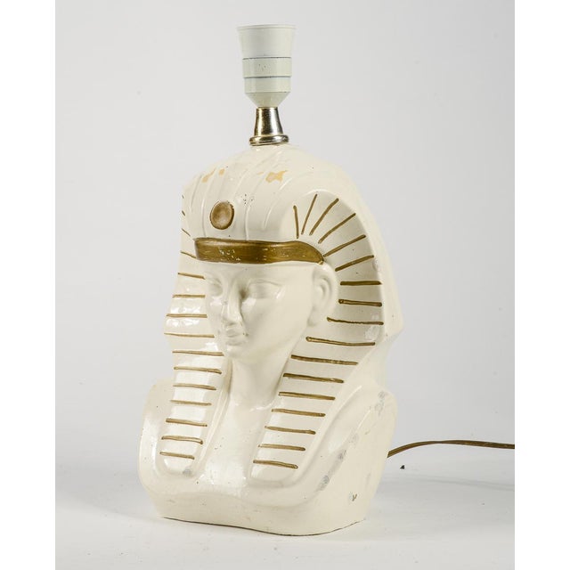Table lamp depicting the Egyptian Faraone god with repairs made in the 1970s when reference to art dean and to the...
