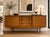 An exceptional Mid Century Modern Walnut Sideboard, beautifully crafted in England and showcasing clean lines, understated...