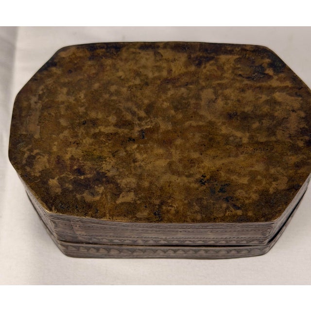 An antique Indian bronze betel nut or paan box, of rectangular form with canted corners and a fitted removable lid. The...