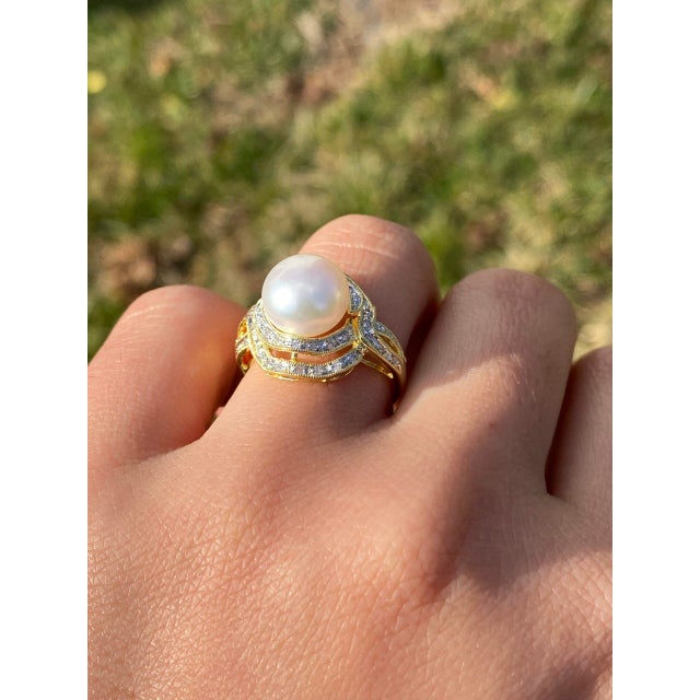 The Malibu Creek: Pearl and Natural Diamond Swirl Ring in Yellow Gold. This elegant ring features a central 10mm cultured...