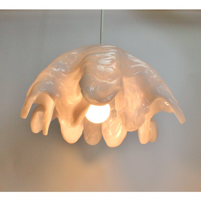 Fabulous and striking pendant light. Made with a unique layering of white and clear resins to have a scalloped shape. Has...