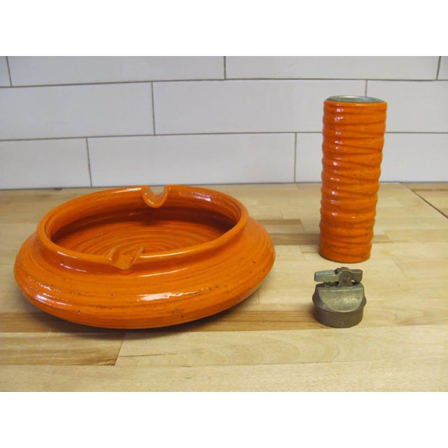 Fantastic pairing of Italian design and ceramics from Rosenthal Netter. A tall ceramic lighter and wide ashtray in a burnt...