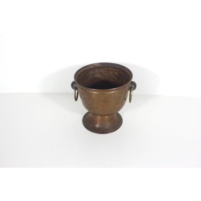 Gorgeous, primitive, rustic hammered copper pedestal planter with handles. This has a wonderful rich patina with a lot of...