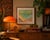 A sunburst beach at the edge of somewhere else — rippling aquamarine water, two pyramids adrift on the tide, agave in...