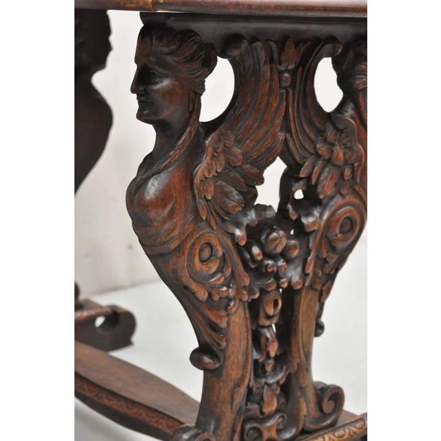 Antique Italian Renaissance Revival Carved Winged Maiden Walnut Mirror Top Side Table. Item features a mirrored top...