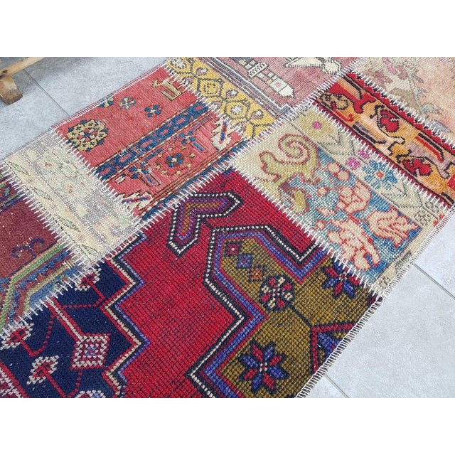 This is a vintage Turkish Oushak rug from the Mid 20th Century. The piece was hand-knotted.