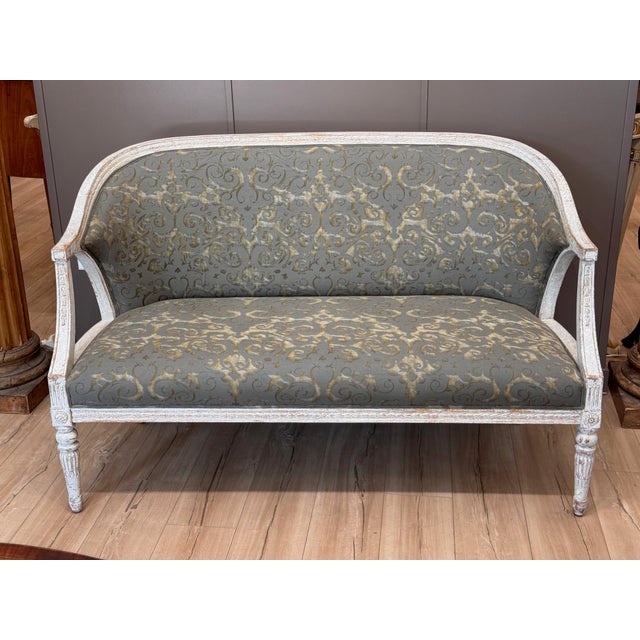 Swedish Gustavian painted settee, 19th C, the curved barrel back sweeping into downswept arms with fluted supports, the...