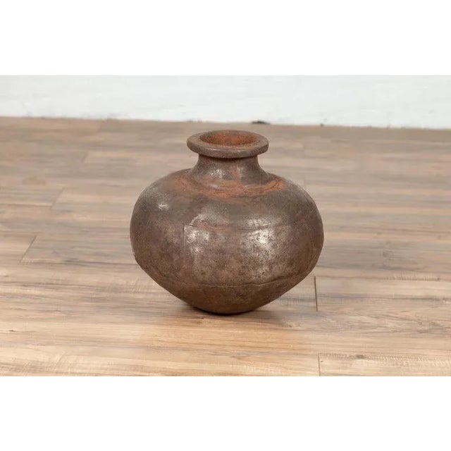 An antique Indian metal water jug from the 19th century, with large belly, flaring neck and large lip. Born in India...