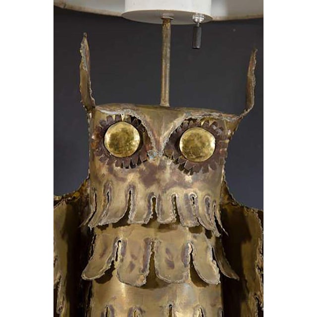A Mid-Century Brutalist table lamp depicting an owl perched on a branch. The lamp sits on an 8" X 8" X 3/4" travertine...