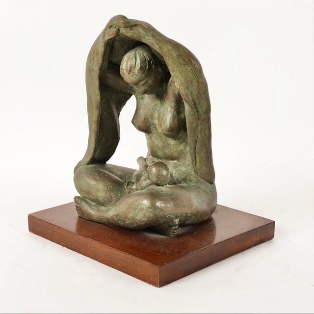 This is a highly evocative small finely cast bronze sculpture of a Mother and Child by the noted Mexican artist Jose Kuri-...