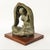 This is a highly evocative small finely cast bronze sculpture of a Mother and Child by the noted Mexican artist Jose Kuri-...