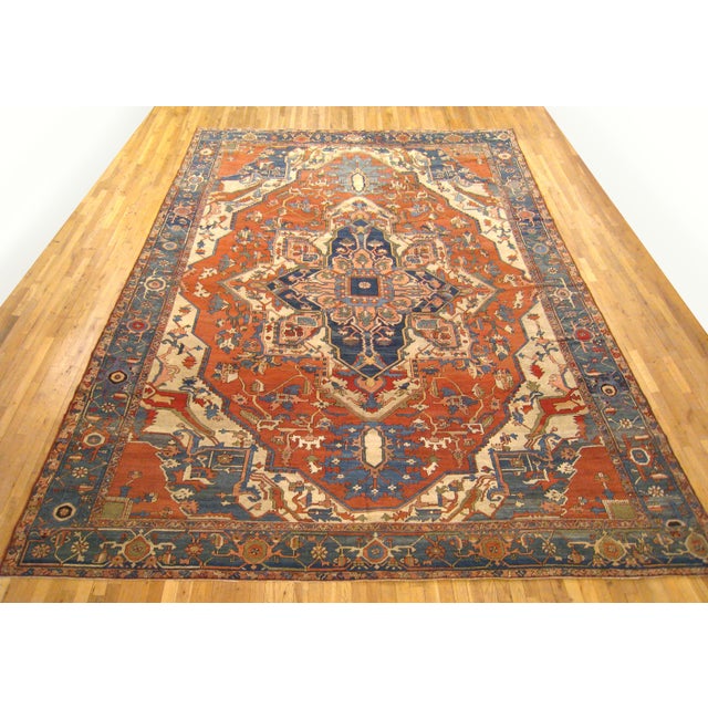 An antique Persian Serapi oriental carpet, size 15'0 x 10'1, circa 1890. This handsome hand-knotted carpet features a...