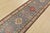 A tribal Caucasian Kazak runner hand-knotted with fine wool on a cotton foundation. This rug features a row of geometric...