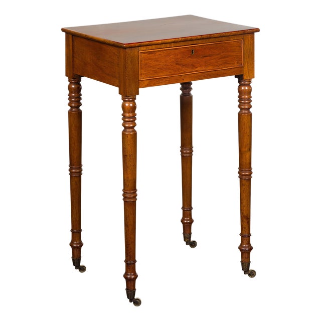English 1820s Walnut Side Table with Single Drawer, Turned Legs and Casters For Sale