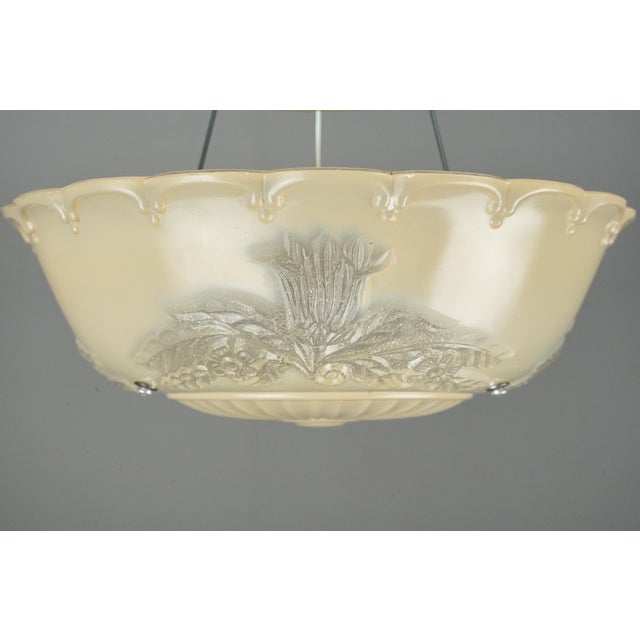 Traditional tan painted floral shade with a chrome finish brass and steel fitter. This requires one standard Edison style...