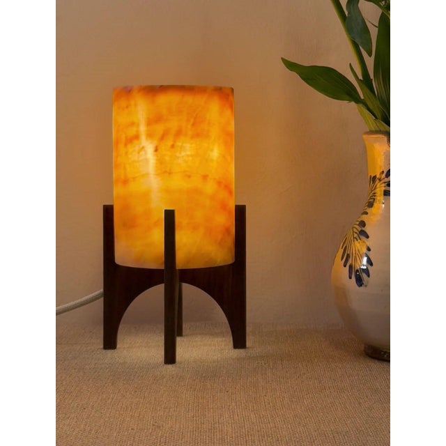 Comet pairs a hand-carved Egyptian alabaster shade with a geometric walnut base, combining contemporary form with...