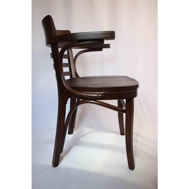 As identified underneath the saddle, this piece was produced in the United States by Thonet Industries during the era...