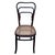 Early Modernist Thonet number 144 side chair features an elegant, sculptural frame crafted from warm-toned bentwood with...