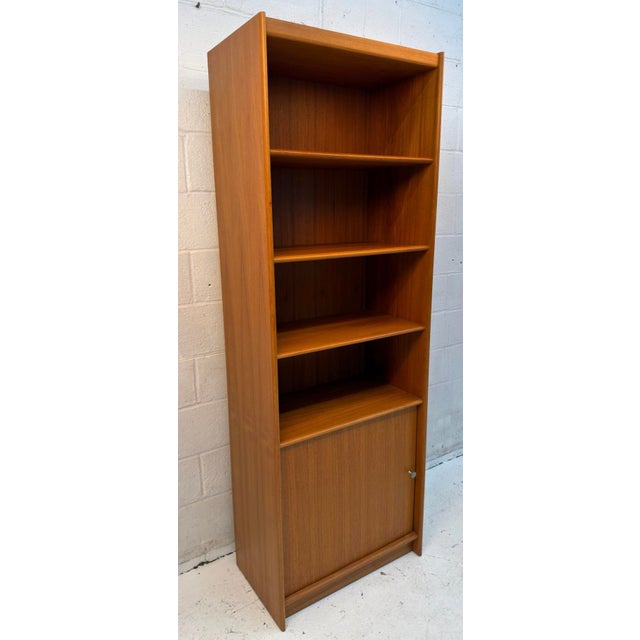 Classic Danish modern bookcase crafted in teak, featuring warm wood tones, rich natural grain, and clean Scandinavian...