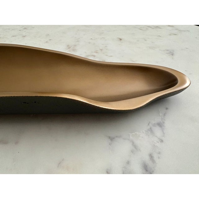 The Laguna Tray invites the eye to examine the subtle contrasts of its shape and textures. Made of solid cast bronze, the...