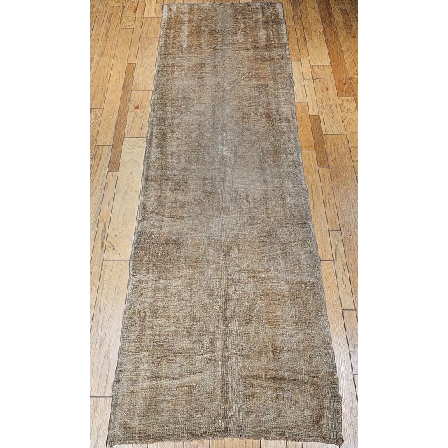 This elegant early 20th century Turkish Oushak wide runner showcases the understated beauty for which Oushak weaving is...