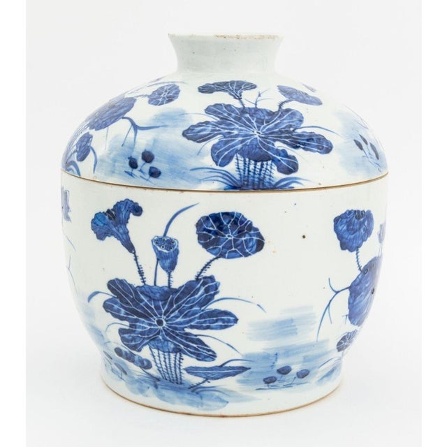 Chinese Blue and White Porcelain Covered Jar, hand-painted with lotus flower motif. 10.5" H x 9.75" Diameter. Provenance:...