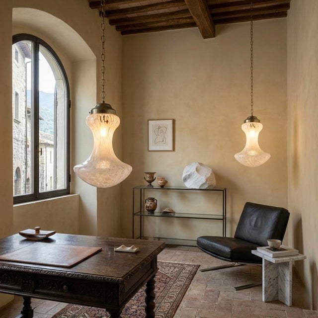 These two pendant lamps are not merely lighting fixtures; they are artifacts of an era, the 1970s, when Italian design...