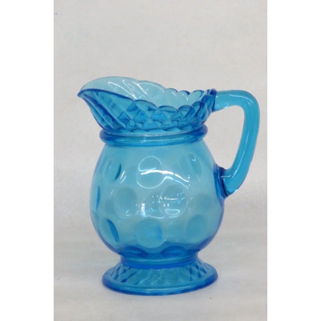 This gorgeous small creamer / pitcher is made of glass. This piece features a lovely blue color and a wonderful dotted...