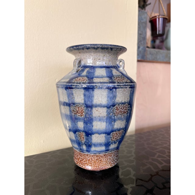 A petite salt glazed studio pottery vase featuring blue and white checkered glazing and three small handles. Signed on the...
