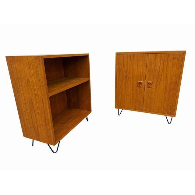 This set of two vintage Danish modern teak hairpin storage cabinets exudes Mid-Century Modern style with its brown teak...