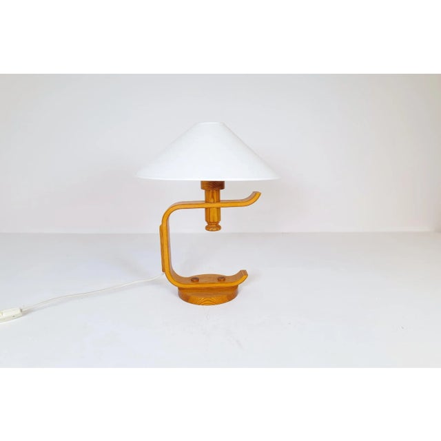 A nice-looking table lamp made in pine. The shape and sculptural way this lamp is put together gives it a nice and modern...