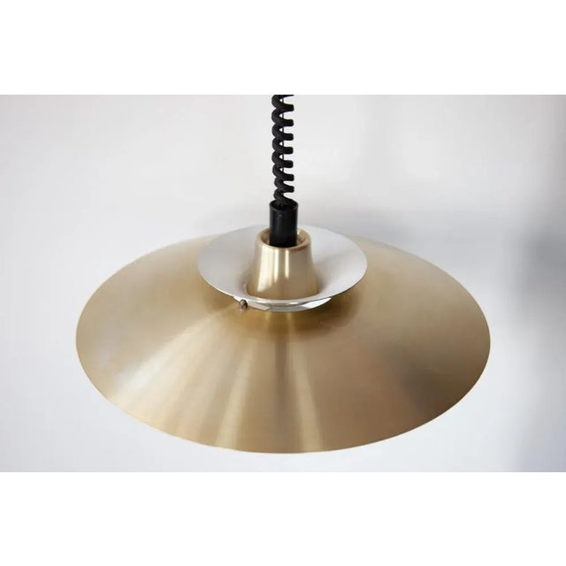 A brushed gold aluminium pendant light with the classic multi shade system designed by jeka of denmark in the 1960's. This...