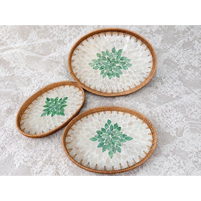 This set of three oval rattan trays is made with traditional mother-of-pearl inlay technology. The outer periphery of the...