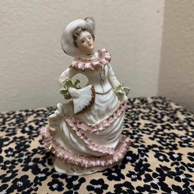 A vintage porcelain figurine of a Victorian lady, produced by the Shafford brand in Japan around the 1950s.