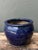 This vintage ceramic planter is a striking example of traditional craftsmanship, featuring a deep, lustrous cobalt blue...