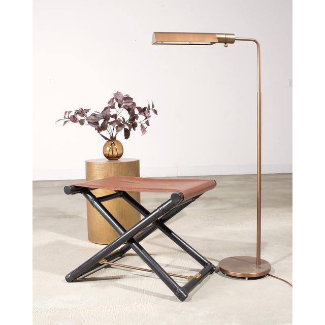Exquisite labeled pair of bronzed pharmacy task floor lamps made by Casella Lighting, California. The pair of lamps...