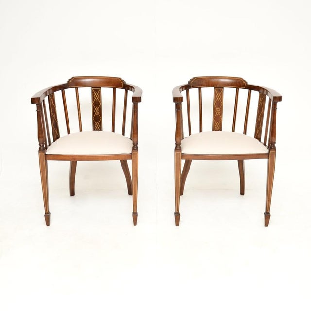 A stunning pair of antique Edwardian inlaid walnut armchairs. They were made in England, and they date from around the...