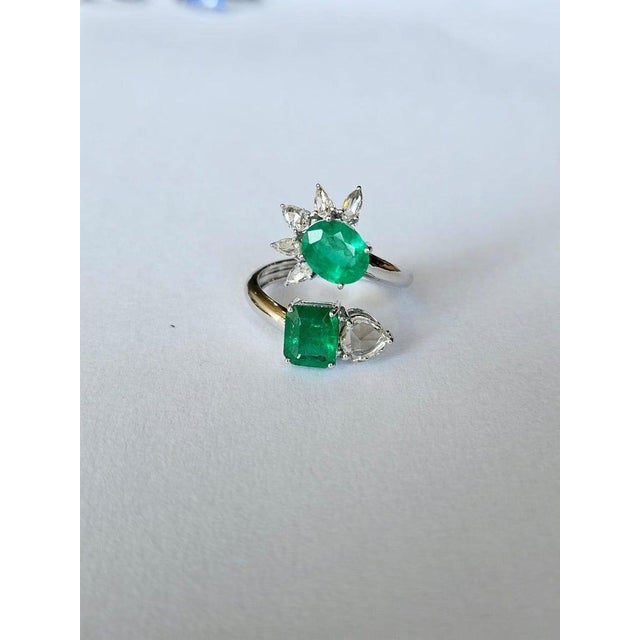 A very gorgeous and beautiful, modern style, Emerald Cocktail Ring set in 18K White Gold & Diamonds. The weight of the...