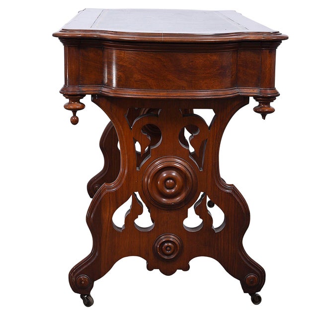 Antique Victorian leather topped walnut library table, circa late 19th century. This antique library table is crafted in...