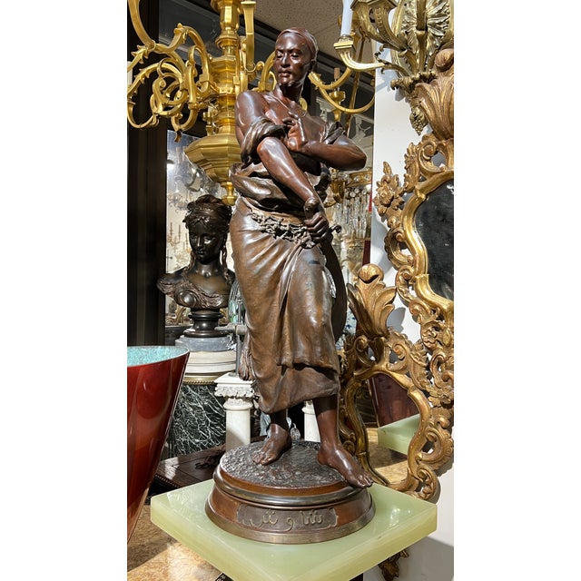 Large 19th century Orientalist patinated bronze sculpture of a lovely Egyptian female beauty carrying water jugs, entitled...