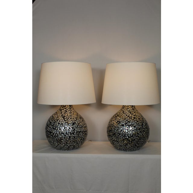 Beautiful pair of Moroccan style lamps. Gracious pear shape. Pearl inlay on black lacquer and gesso base. The high glass...