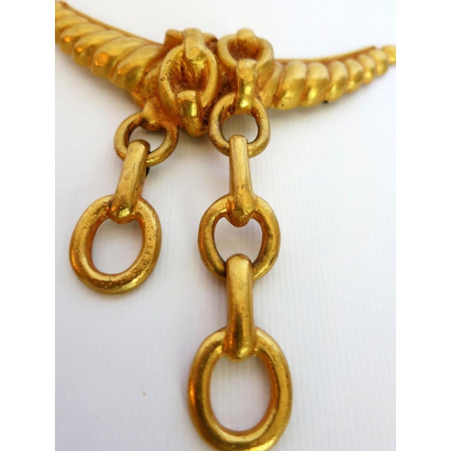 A gilt bronze brooch by French art jewelry designer Line Vautrin (1913-1997) Untitled circa late 1940s. The brooch depicts...