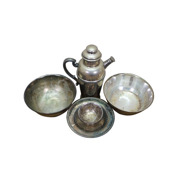 This diverse five-piece vintage silver plated lot features a collection of classic barware and serving essentials...