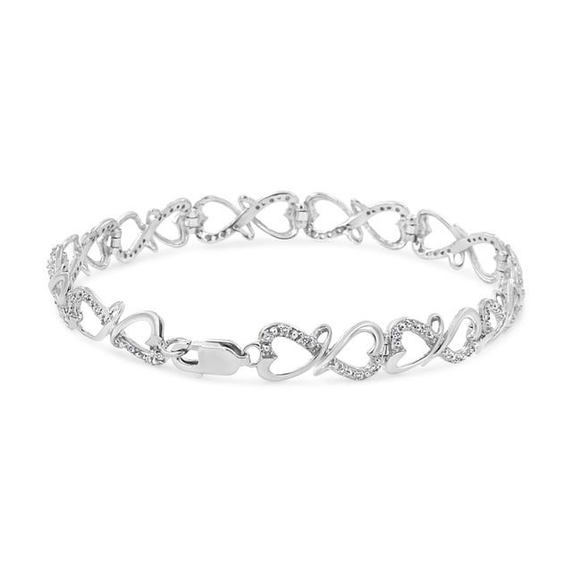 Modern and chic, this beautiful silver bracelet is elegantly crafted with a double heart link design. The metal is genuine...
