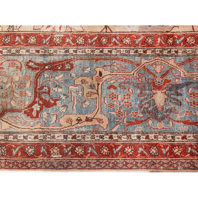 An early 20th century Persian Antique Tabriz rug, the caramel field with a spacious lattice in shades of green, orange and...